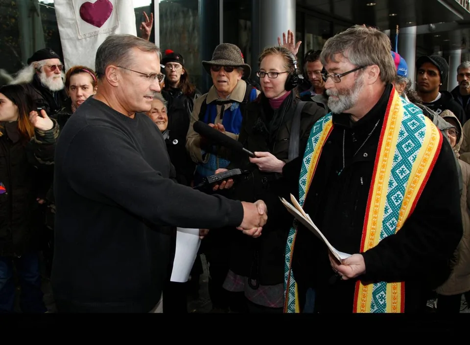 Rev. Rich Lang in alb and stole on the street, Seattle